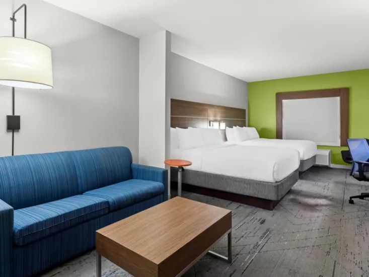 Modern hotel room interior with a made-up bed