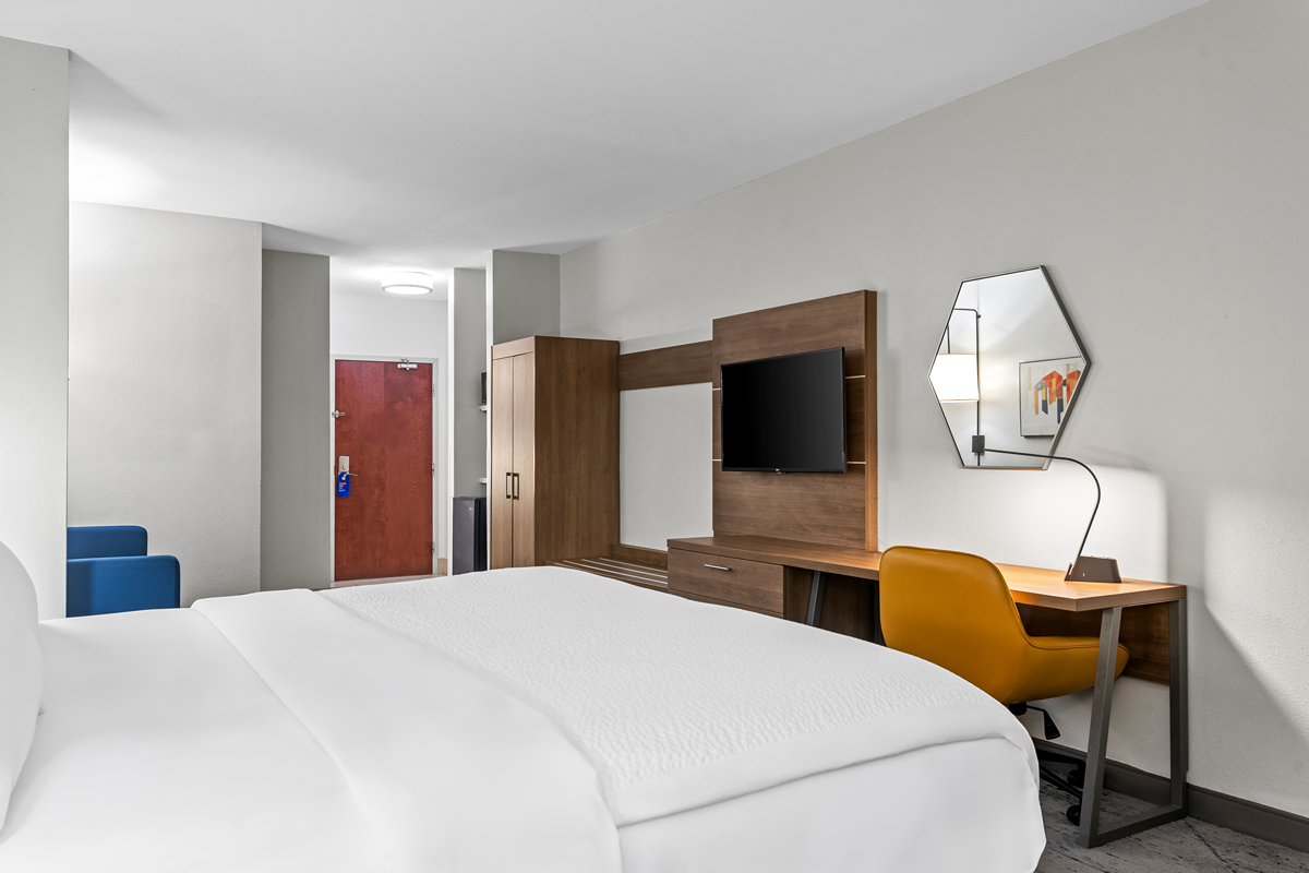 Guest room with workspace and bed